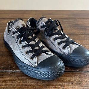 Gray and black low top studded converse